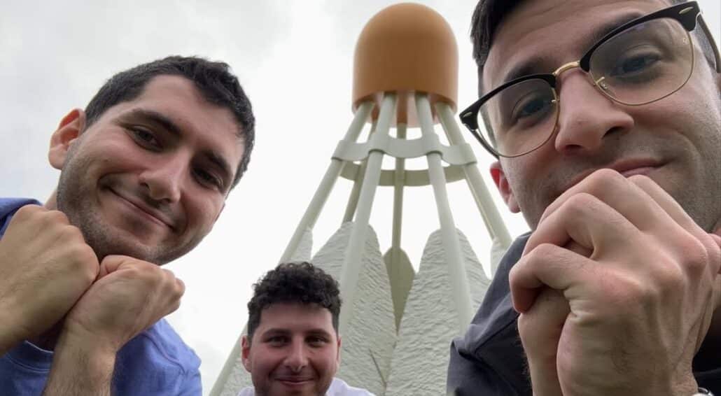 Zack and friends at a statue of a shuttlecock.
